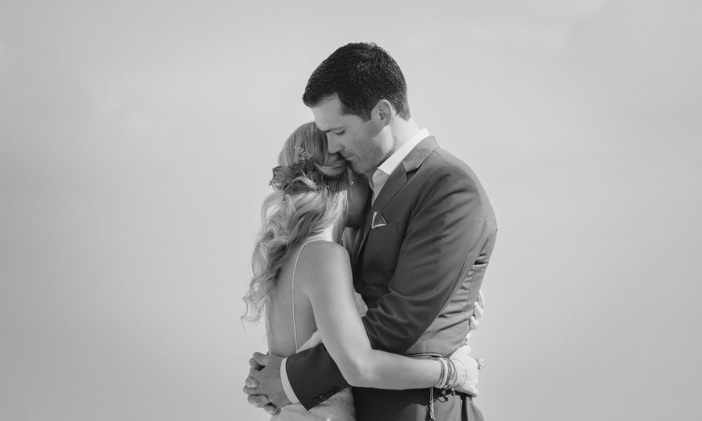 wedding photographer Cape Cod captures black & white portrait of bride and groom embracing eachother