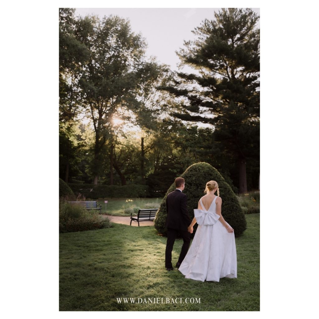 Bride and groom portrait walking to join their guests at luxury wedding in the North Shore.