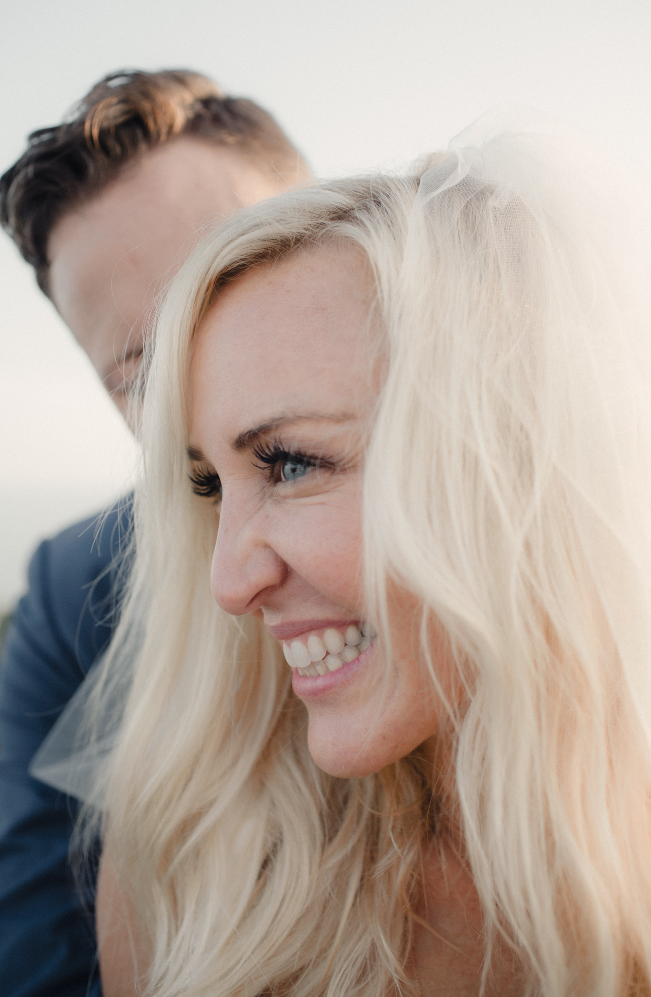 Wedding portrait of bride and groom, groom hugging bride playfully captured by wedding photographer on Cape cod, Daniel Baci
