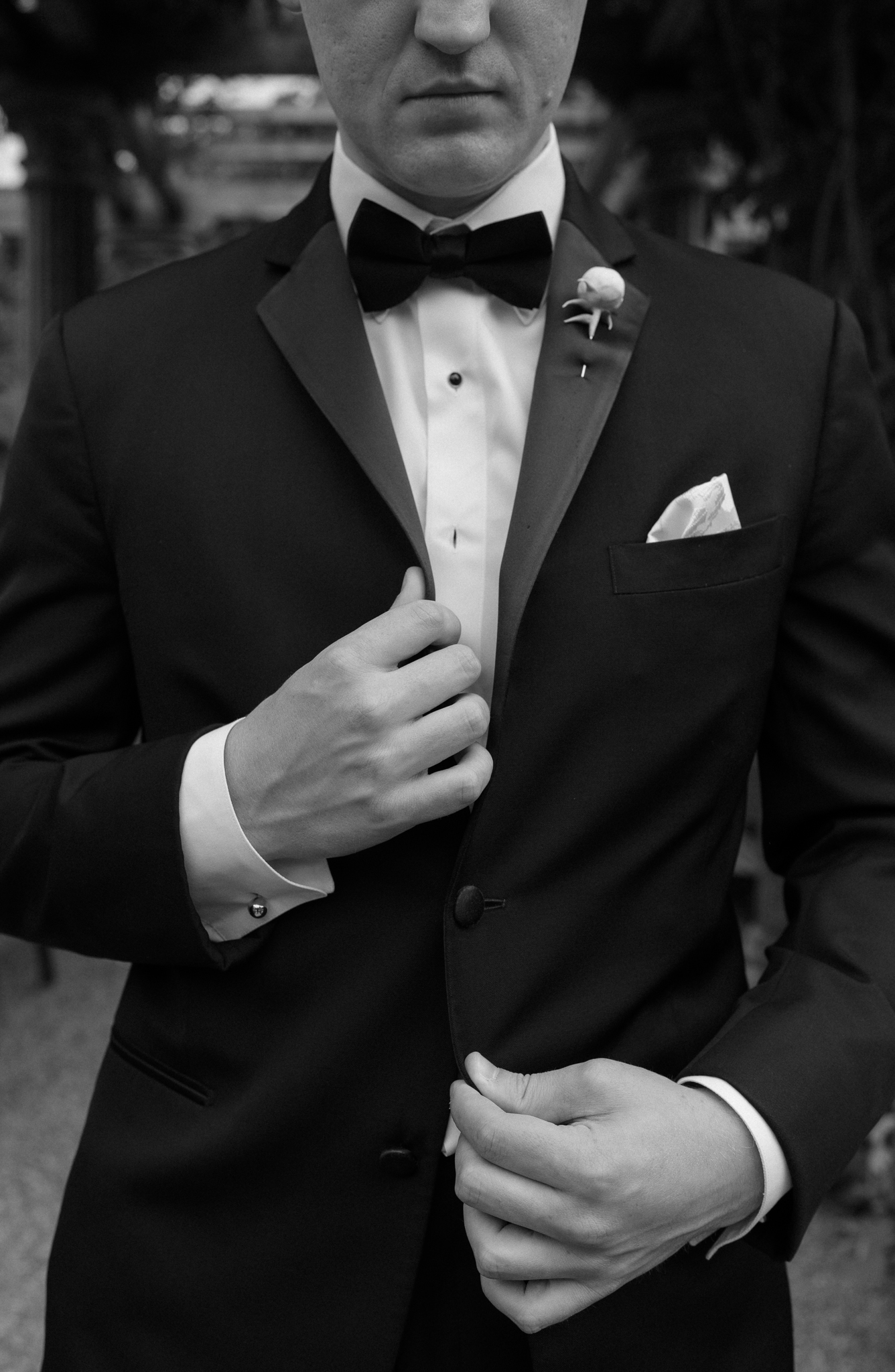 Groom fixing his jacket while posing for photo with Luxury wedding photographer in Cape Cod, Daniel Baci