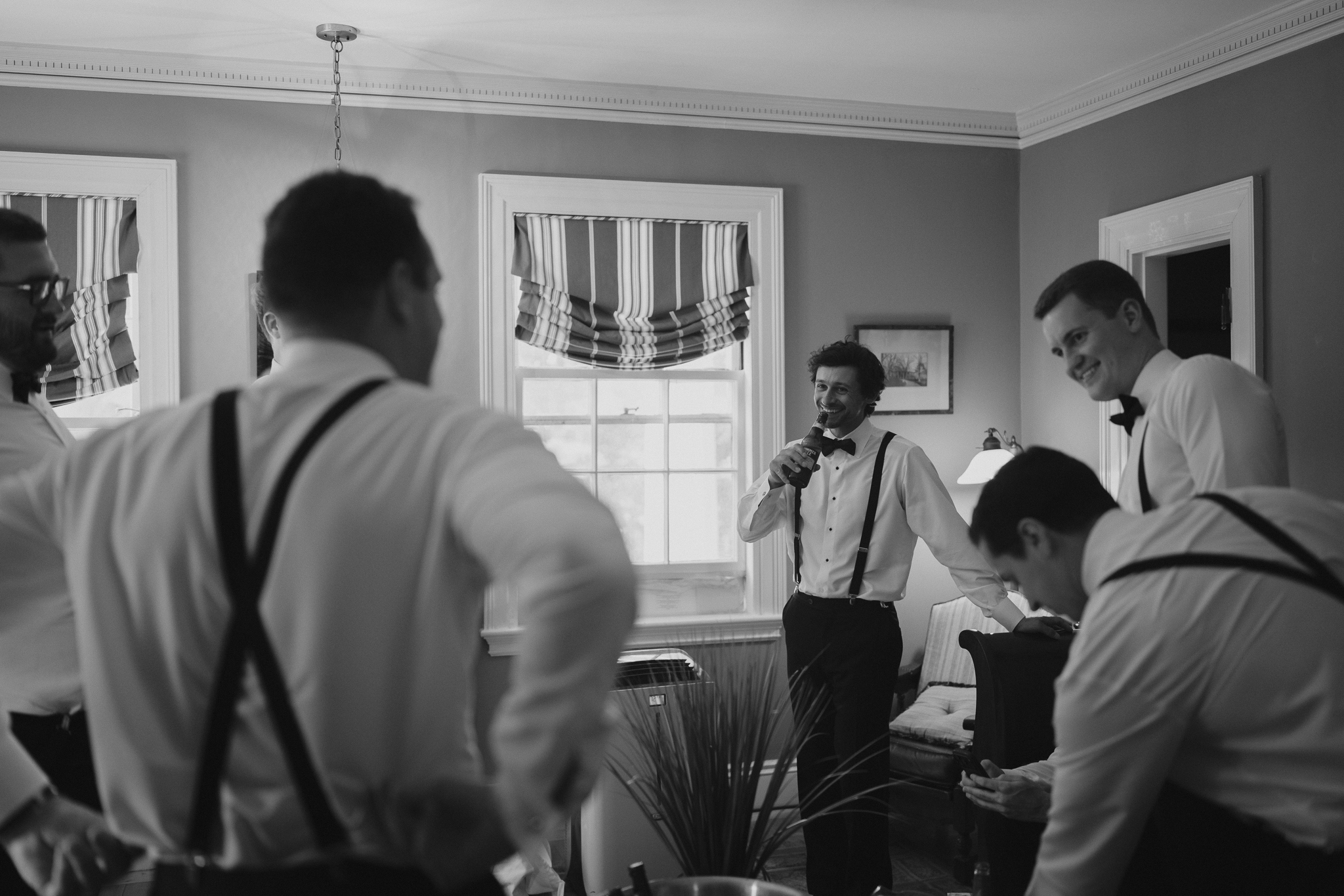 Candid photo of groomsmen hanging out before their ceremony begins by Daniel Baci photography