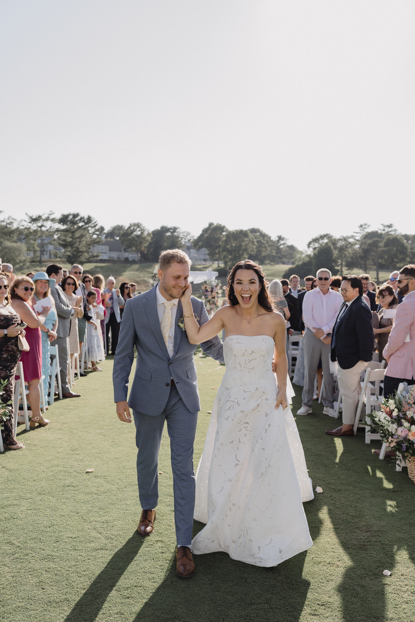 Bride and groom walk down the aisle at their Cape Cod wedding ceremony in Mashpee, captured by Daniel Baci Photography