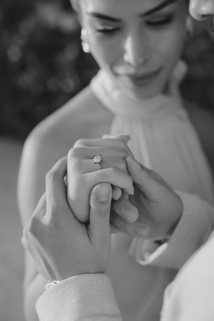 Close portrait of the bride and groom holding hands