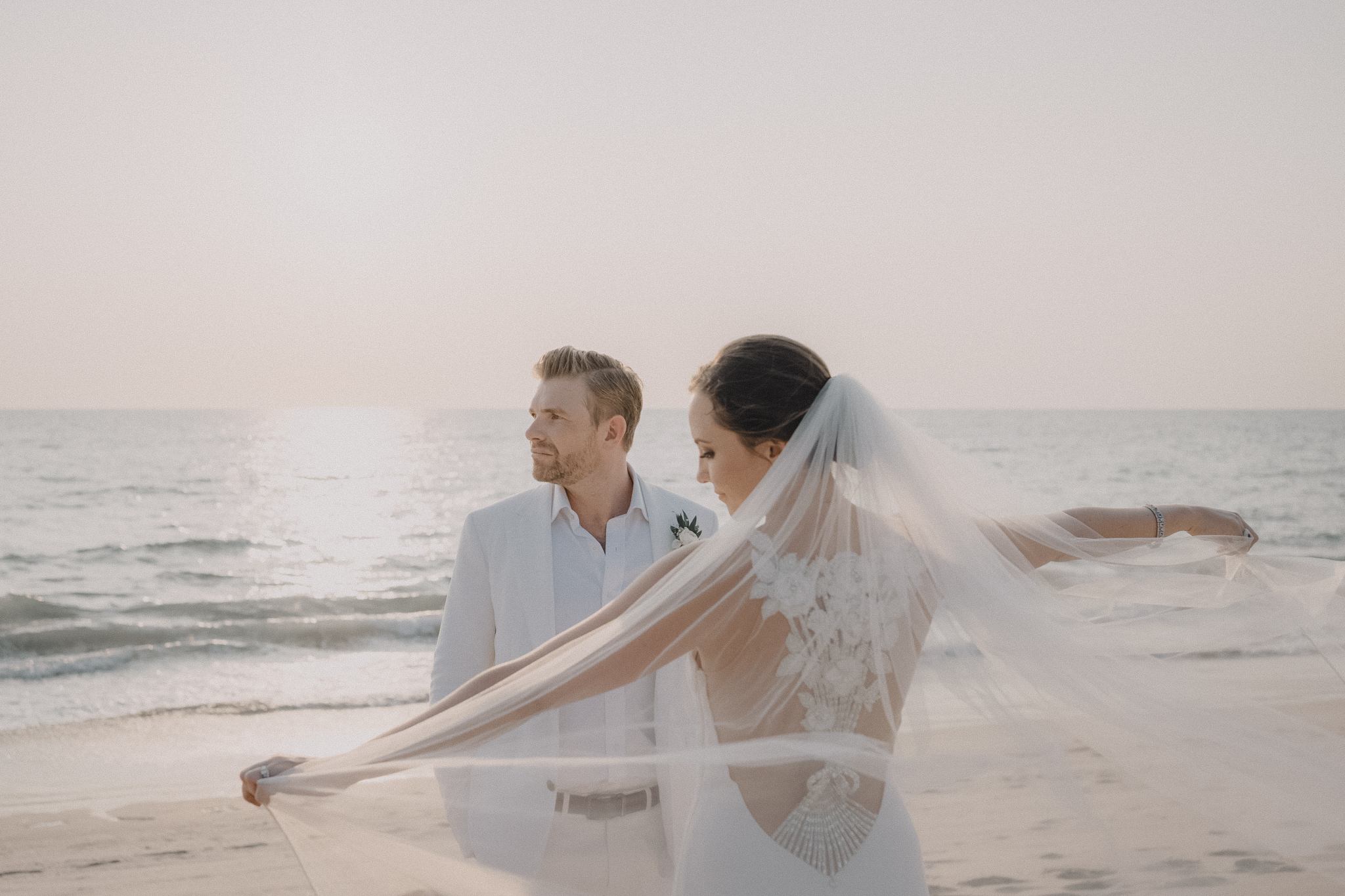 Soft portrait of bride and groom during the golden hour on the beach in Cape Cod, beautifully captured by Daniel Baci Photography