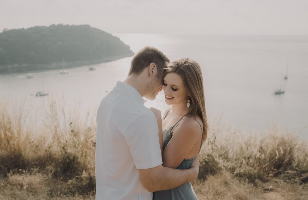 Couple embracing at their wedding by the water