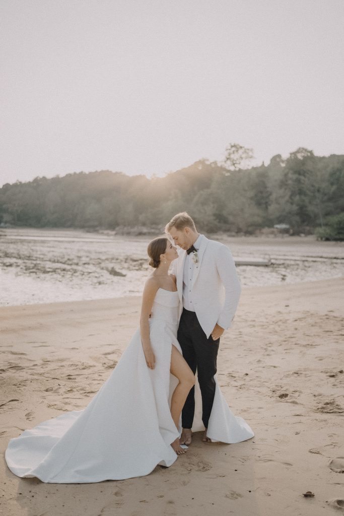 Bride and groom walking at sunset
