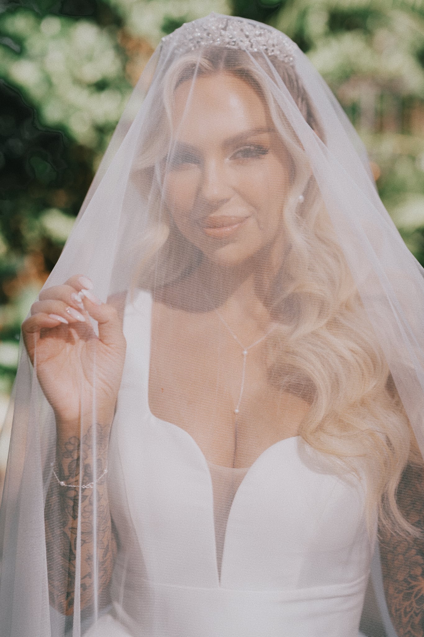 Brides portrait under her veil posing for Cape Cod wedding photographer Daniel Baci